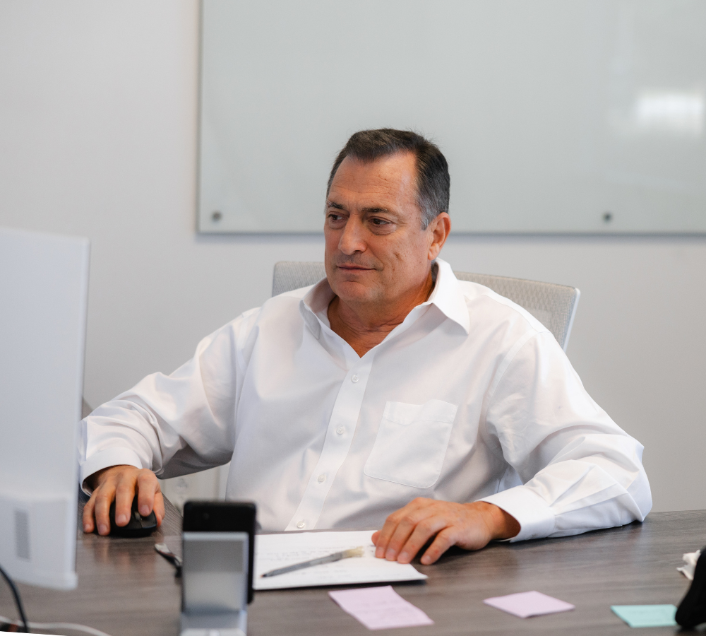 John Boettigheimer working at a desk