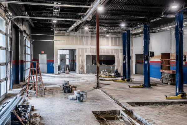 Automotive workshop under construction with service bay lifts
